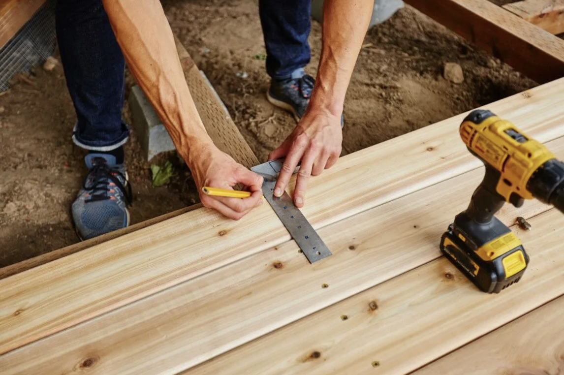 Custom deck builder measuring boards in Schertz, TX